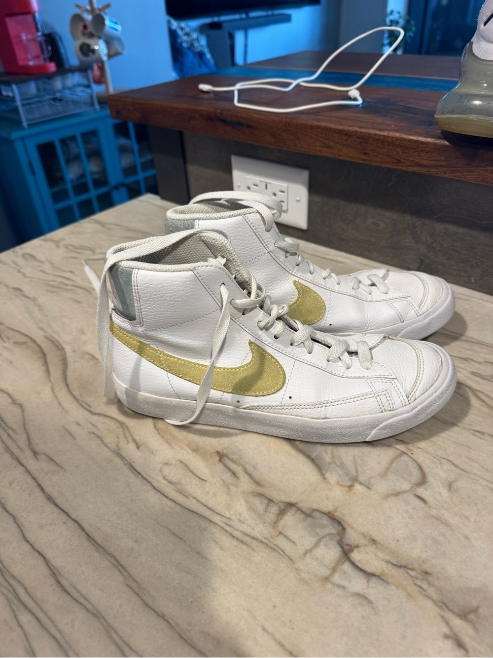 Nike Kids White High-Top Sneakers with Gold Swoosh Accent